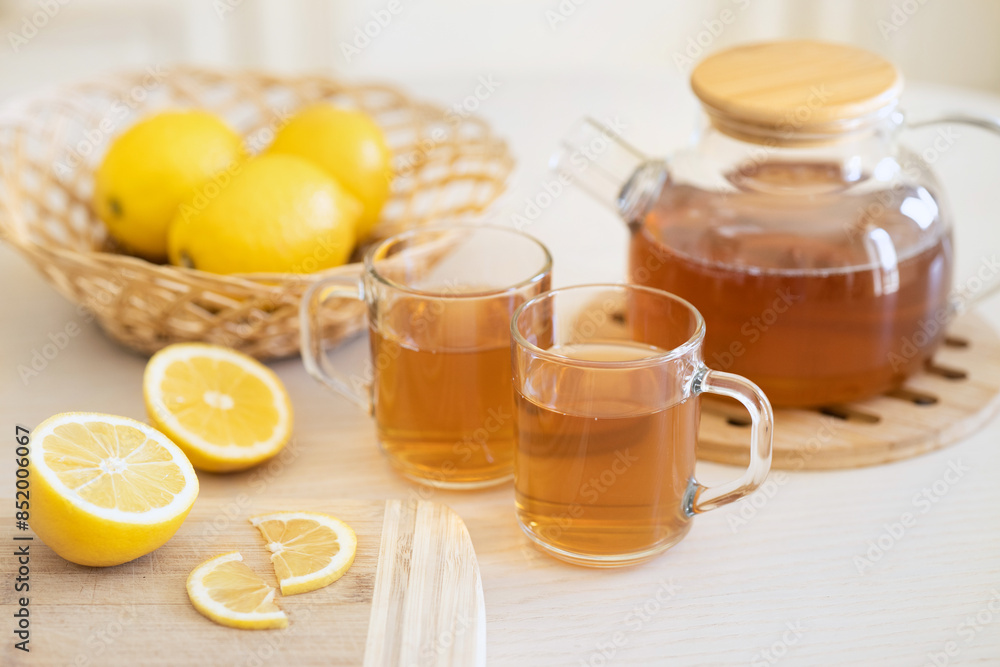 Tea with slice of lemon and honey on wooden table and blue background Tea with slice of lemon and honey on wooden table and blue background