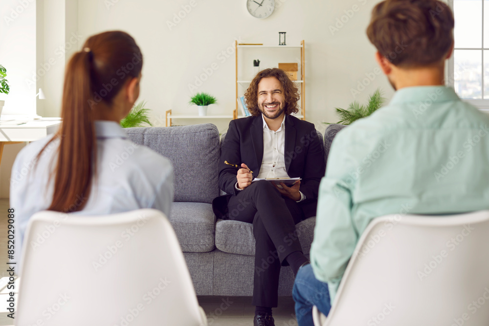 Therapy session with a family couple, smiling doctor psychologist creates a supportive consulting environment. Witness the positive impact as the expert guides towards happiness and understanding. Therapy session with a family couple, smiling doctor psychologist creates a supportive consulting environment. Witness the positive impact as the expert guides towards happiness and understanding.