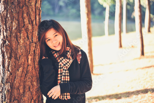 Portrait young asian female smiling with pine and lake in Mae Hong Sorn province of Thailand on left frame photo