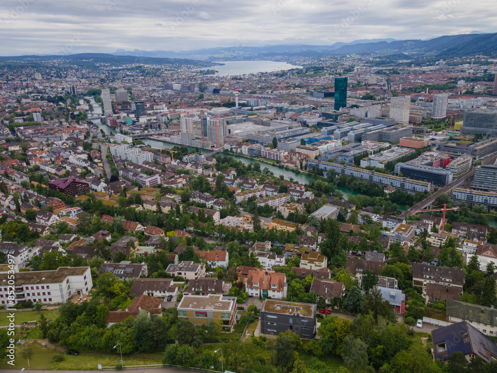 Fototapeta premium Zurich Switzerland residential area by the river Limmat with industrial area on the other riverside towards the lake, aerial view, drone shot