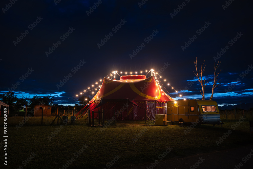 small circus tent with row of lights on in the evening small circus tent with row of lights on in the evening