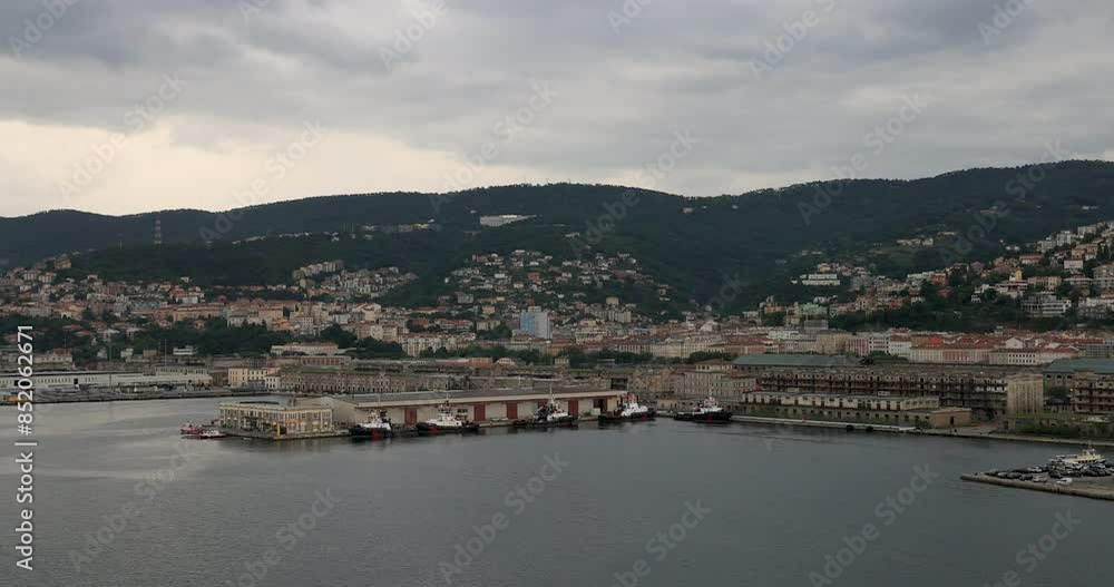Trieste Italy commercial tug boat harbor port city. City seaport in northeastern Italy. Adriatic Sea and Slovenia. Seaport and a prosperous trading hub in the Mediterranean. Historical buildings. Trieste Italy commercial tug boat harbor port city. City seaport in northeastern Italy. Adriatic Sea and Slovenia. Seaport and a prosperous trading hub in the Mediterranean. Historical buildings.