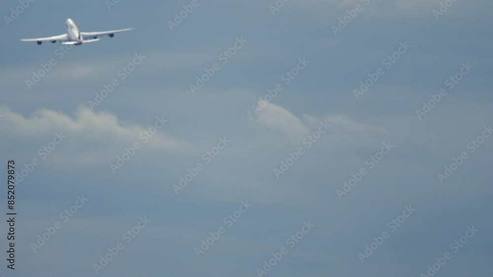Long shot rear view of a huge jet aircraft climbing after takeoff. Footage of the airliner flying away Long shot rear view of a huge jet aircraft climbing after takeoff. Footage of the airliner flying away