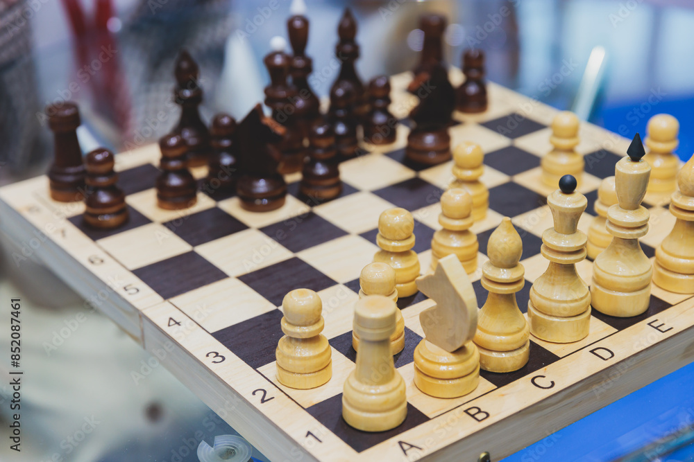Chess tournament, kids and adults participate in chess match game in indoor hall, players of all ages play, competition in chess school club with chessboards on a table, wooden pieces Chess tournament, kids and adults participate in chess match game in indoor hall, players of all ages play, competition in chess school club with chessboards on a table, wooden pieces
