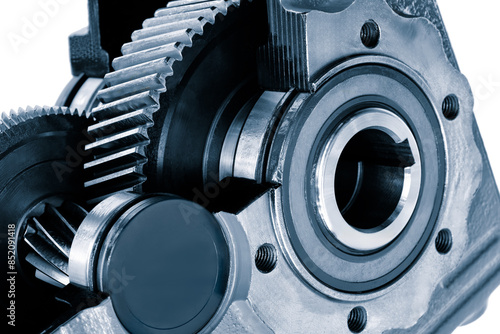 A close up of a gear with a black cap on it. The gear is part of a larger machine photo