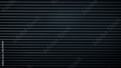 A black and white backgroundof a metal surface with a lot of lines photo