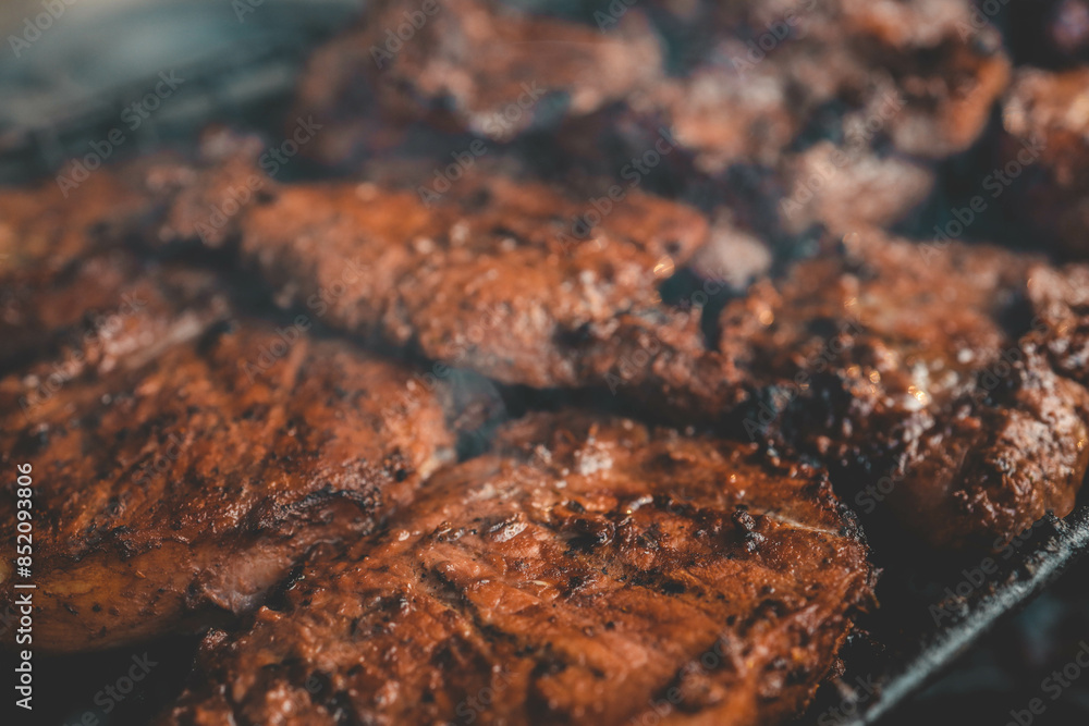 Man hand grilling barbecue with smoked pork at backyard on day. Family dinner outdoor style bbq activity Man hand grilling barbecue with smoked pork at backyard on day. Family dinner outdoor style bbq activity
