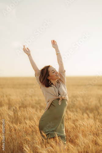 An exuberant woman raises her arms in celebration amidst a vast, sunlit wheat field, conveying a sense of freedom and happiness.