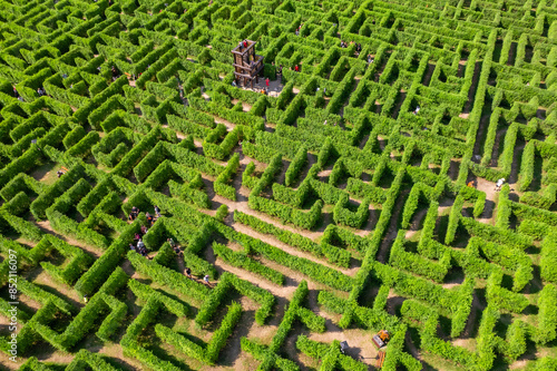 Obraz na płótnie Aerial view of people trying to find exit in a labyrinth garden at sunny day w salonie