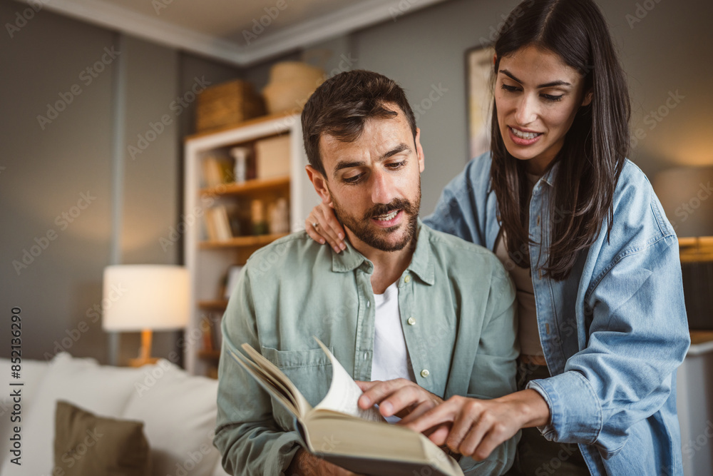 Boyfriend read a book while girlfriend hug him love, happiness Boyfriend read a book while girlfriend hug him love, happiness