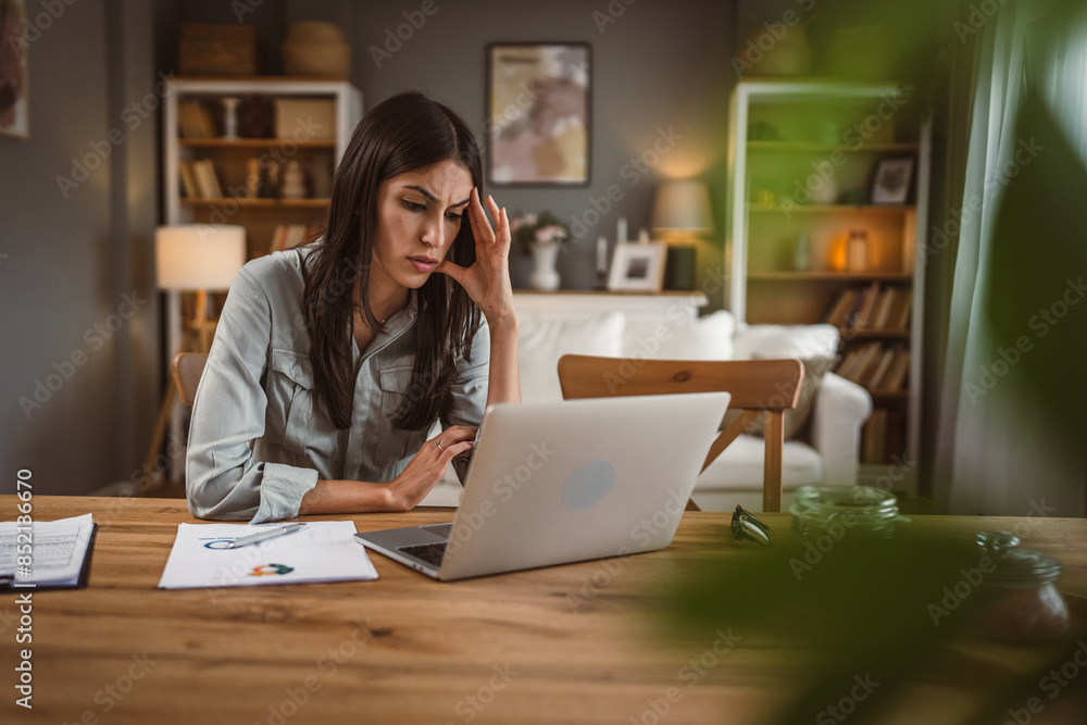 Exhausted caucasian woman work from home on laptop read statistics Exhausted caucasian woman work from home on laptop read statistics