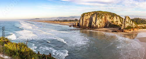 Guarita beach with waves, cliffs and winter fog over the trees
