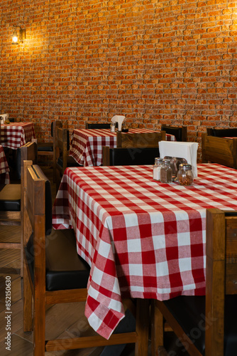 Cozy Restaurant Interior with Checkered Tablecloths and Brick Wall