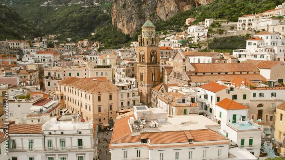 View of Amalfi town with historic buildings and mountains in the background. Summer in Italy. View of Amalfi town with historic buildings and mountains in the background. Summer in Italy.