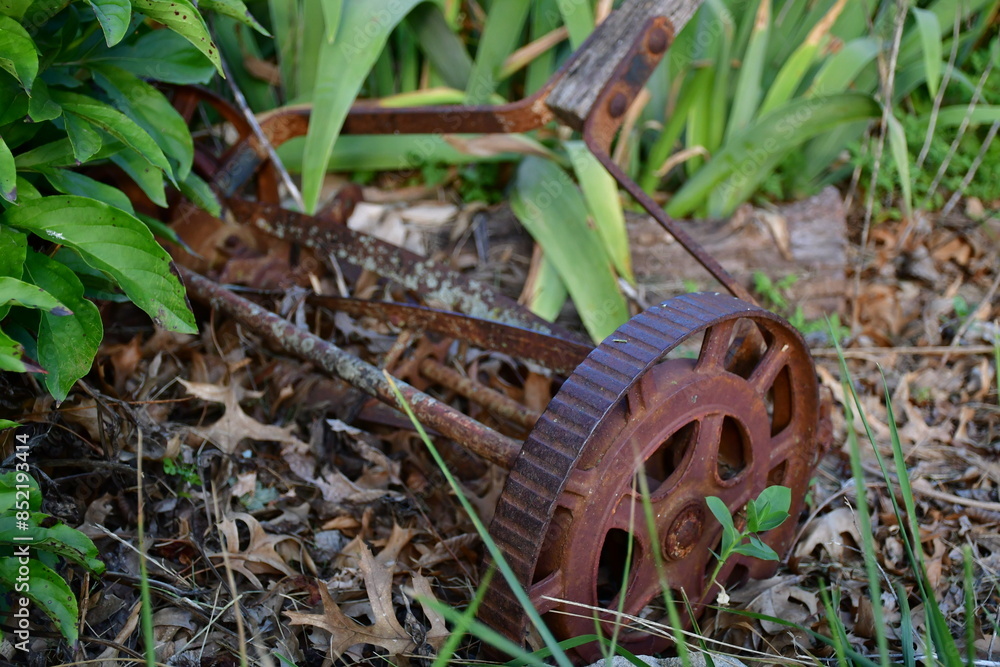 Antique Lawn Mower in a Garden Antique Lawn Mower in a Garden