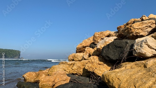 Beautiful landscape of beach with stone on the foreground