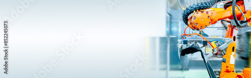 Close-up of the robot automating a mechanical process in a factory. web banner size