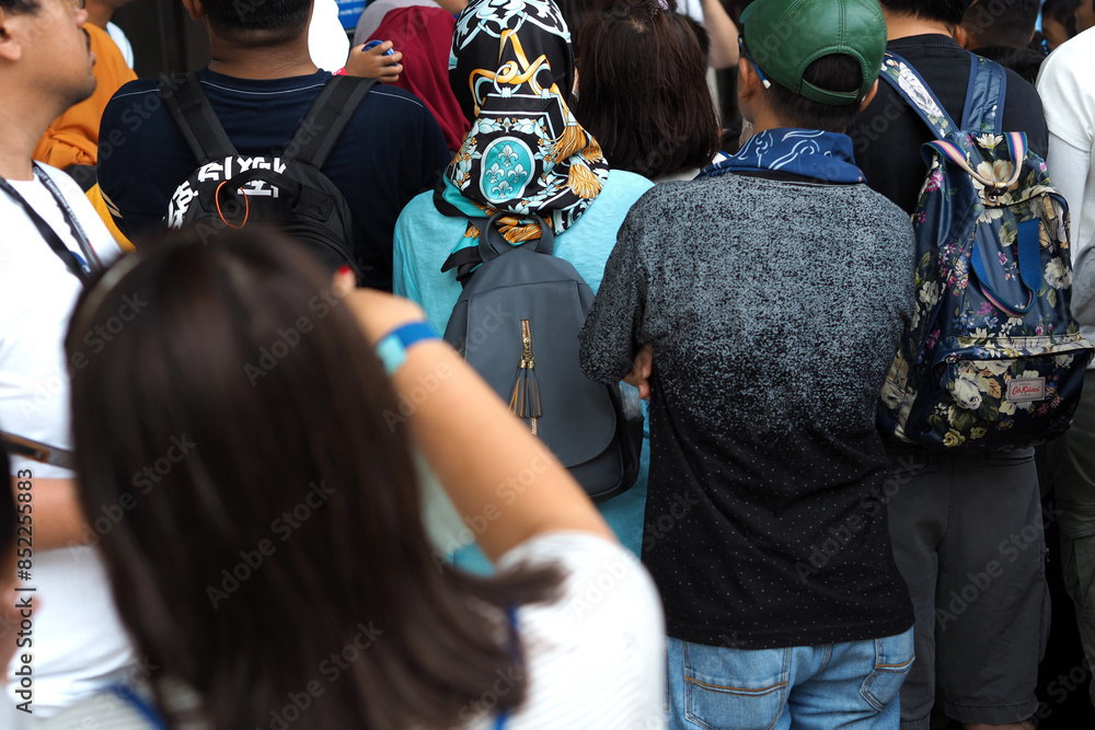 Fototapeta premium visible from behind the people queuing