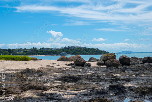 Obraz na płótnie Panoramic View of Maraetai Beach Auckland, New Zealand; Rocky Parts of the Beach during Low Tide w salonie