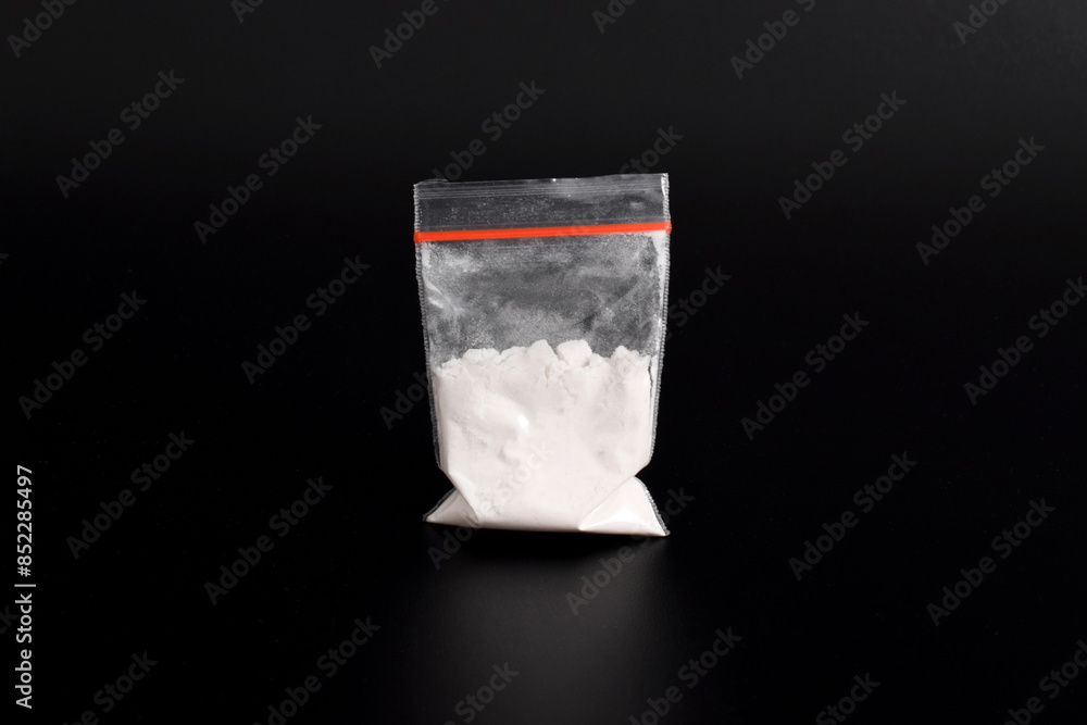 Cocaine in plastic packet isolated on black background. illustration of illegal drug substances, narcotics Cocaine in plastic packet isolated on black background. illustration of illegal drug substances, narcotics