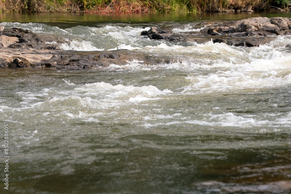 Fototapeta premium Water flows in the rocky Waitangi river 