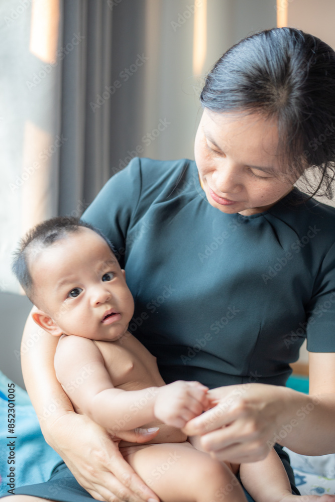 Office women playing with infant baby boy in cozy room Office women playing with infant baby boy in cozy room