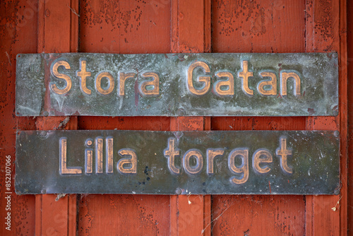 Sigtuna, Sweden An old-fashioned street sign says Stora Gatan and Lilla Torget, or Big Street and Small Square, in English trnaslation. photo