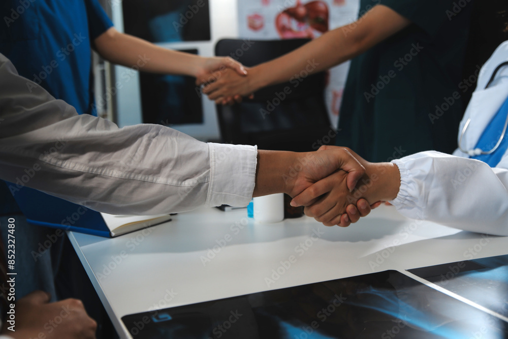 Obraz premium Doctor handshake and partnership in healthcare, medicine or trust for collaboration, unity or support.Team of medical experts shaking hands in teamwork for or success in hospital