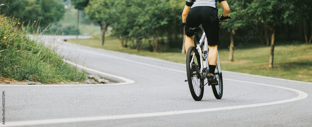 Obraz premium Mountain biking on summer forest trail