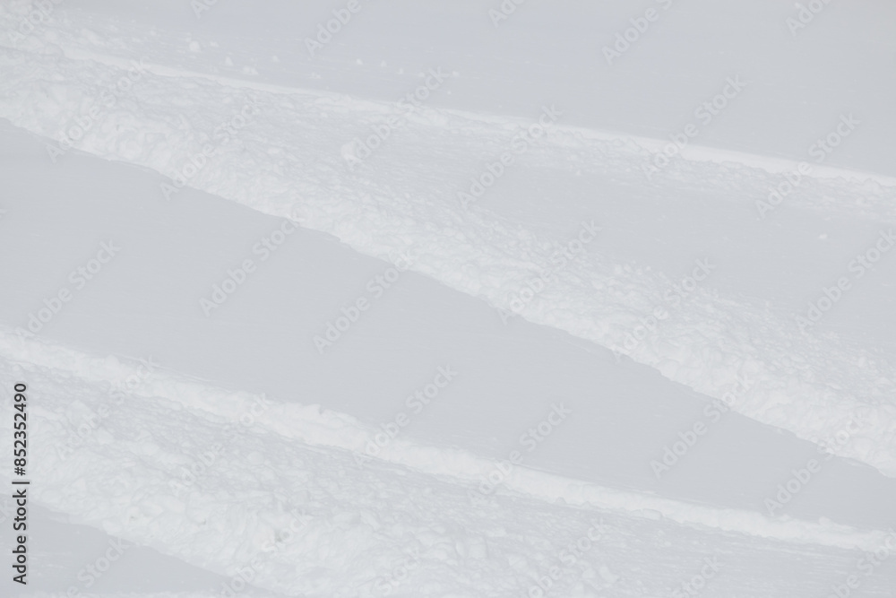 Snowboard track in fresh white winter powder snow abstract background Snowboard track in fresh white winter powder snow abstract background