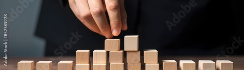 Business Development and Growth Success Process Concept with Hand Arranging Wooden Blocks