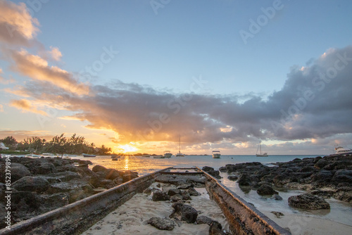 Landscape with a view over a small harbor with fishing boats. Tropical landscape with sunset view at Cape Malheureux, Mauritius