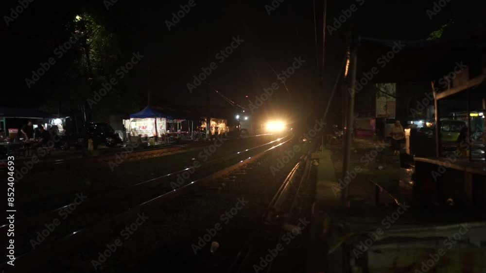 Bogor, June 7 2024. A busy street at night illuminated by vehicle headlights and street lamps, capturing the dynamic glow and activity of urban nightlife Bogor, June 7 2024. A busy street at night illuminated by vehicle headlights and street lamps, capturing the dynamic glow and activity of urban nightlife