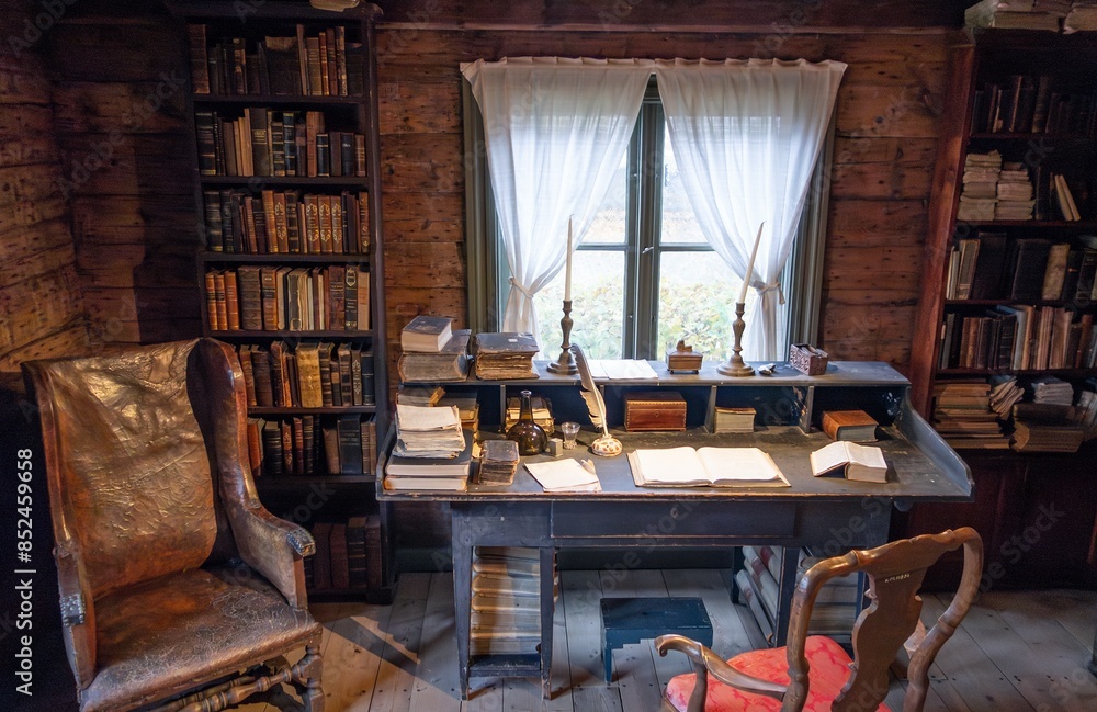 Interior of old library with vintage furniture, chair, table and books