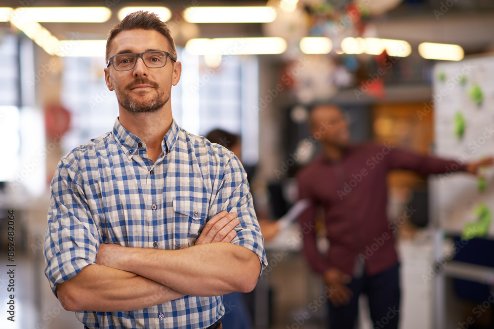 Obraz premium Portrait, glasses and business man with arms crossed in startup office for pride in career or job. Creative, face and confident professional entrepreneur, copywriter and employee coworking at company