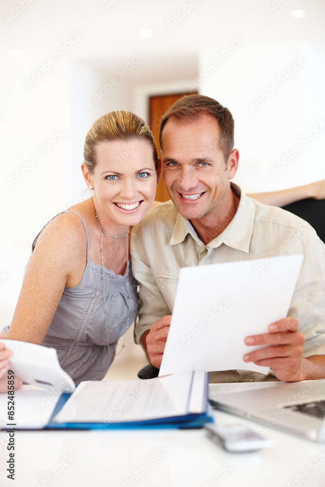 Couple, home and paperwork with documents in portrait for calculating house finances, budget, taxes and mortgage at table. Happy, people and holding savings account bills for growth of property plan Couple, home and paperwork with documents in portrait for calculating house finances, budget, taxes and mortgage at table. Happy, people and holding savings account bills for growth of property plan