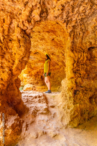 A female tourist exploring a cave in the Monasterio de Piedra Natural Park, Aragon