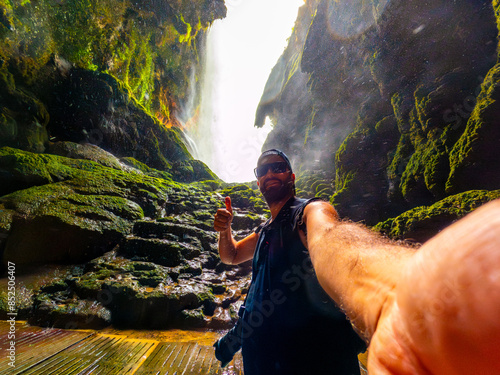 A tourist inside the Iris grotto at the Cola de Caballo Waterfall in the Monasterio de Piedra Natural Park, Aragon