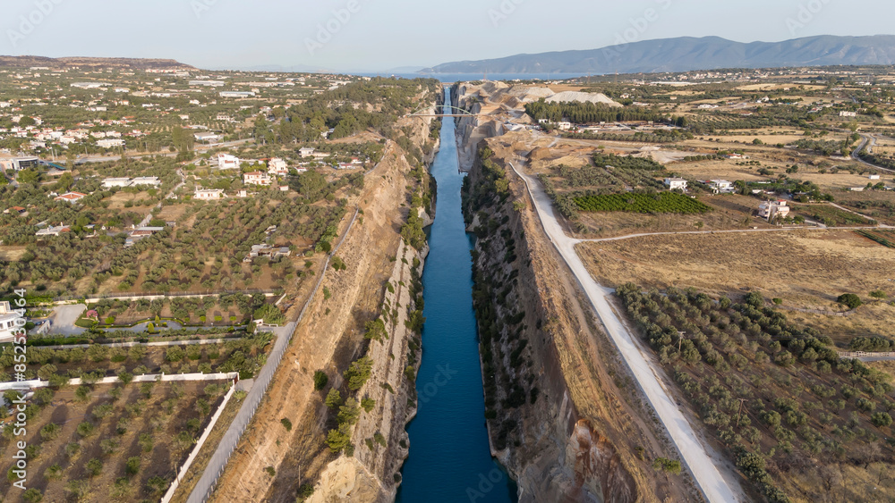 Corinth Canal, Greece. The Corinth Canal is a sluiceless shipping canal in Greece, connecting the Saronic Gulf of the Aegean and the Gulf of Corinth of the Ionian Sea, Aerial View Corinth Canal, Greece. The Corinth Canal is a sluiceless shipping canal in Greece, connecting the Saronic Gulf of the Aegean and the Gulf of Corinth of the Ionian Sea, Aerial View