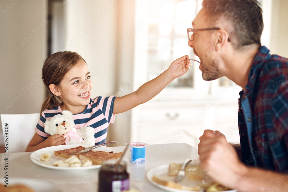 Breakfast, feeding and daughter with dad, smile or morning in kitchen, toast or dining table in home. Healthy, family or food for father, child and man in house, eating and bonding with love together Breakfast, feeding and daughter with dad, smile or morning in kitchen, toast or dining table in home. Healthy, family or food for father, child and man in house, eating and bonding with love together