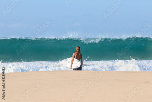 surfer walking on the beach