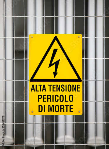 power plant warning sign with text in Italian that means HIGH VOLTAGE DANGER OF DEATH photo