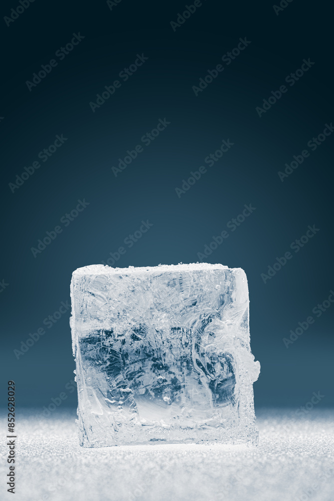 Natural crystal clear single ice cube on a dark background. Natural crystal clear single ice cube on a dark background.