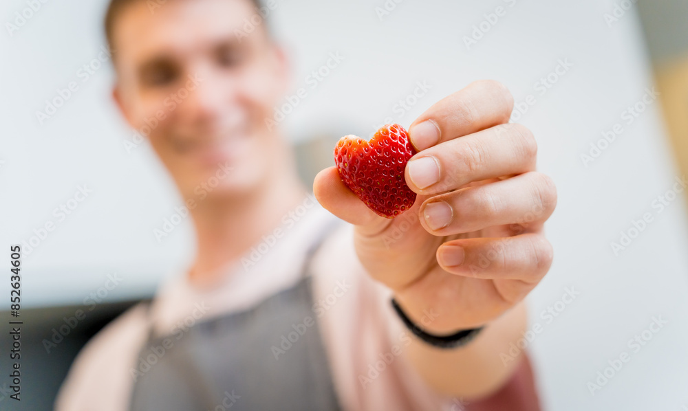 Chef at the kitchen preparing bowl of oats with strawberries and mango Chef at the kitchen preparing bowl of oats with strawberries and mango