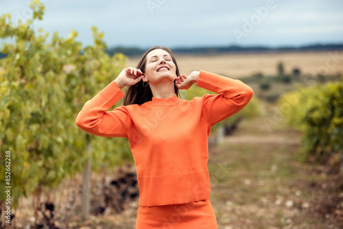 Portrait of adorable woman looking up against sky background