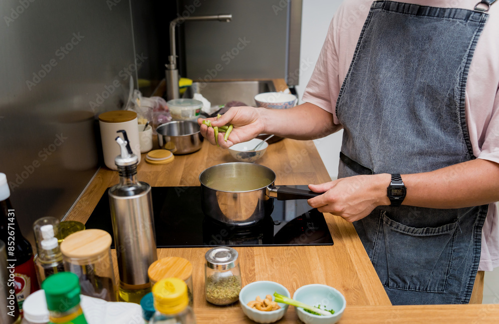 Chef at the kitchen preparing green curry with herbs and rice Chef at the kitchen preparing green curry with herbs and rice