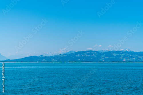 Obraz na płótnie Germany, wonderful view to white snow covered mountain peaks of the alps and switzerland from lindau in summer with blue sky panorama w salonie