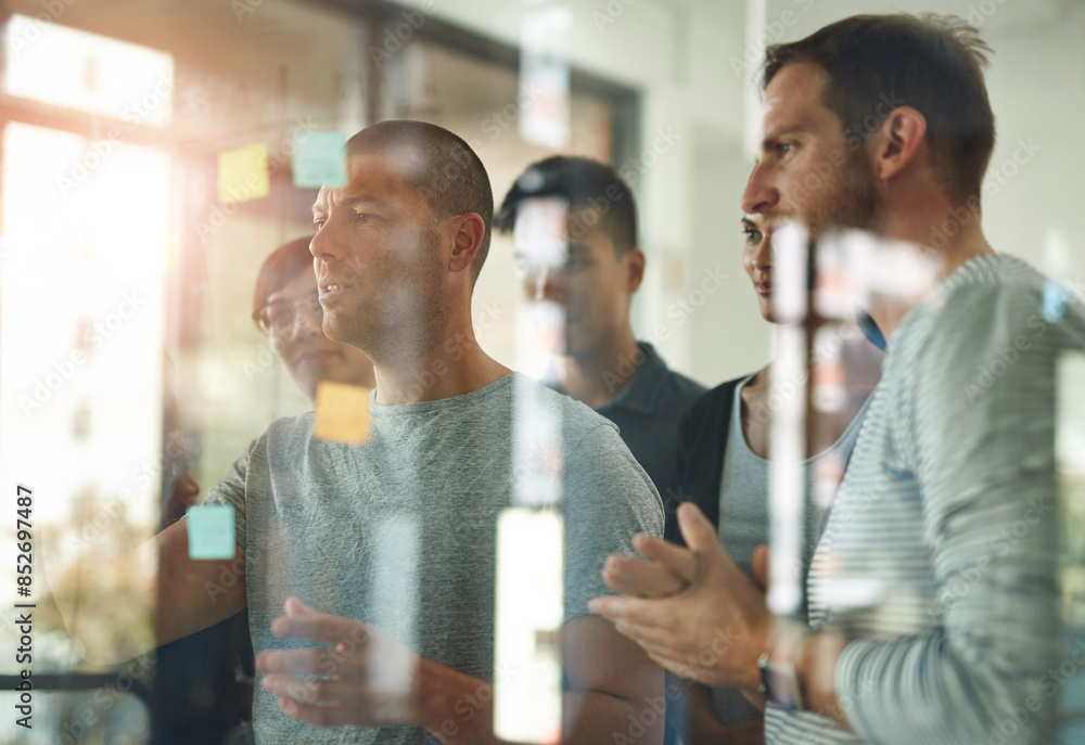 © Cecilie S W/peopleimages.com - Glass, planning and talking with business people in office together for coaching or training. Discussion, meeting and storyboard with employee team in workshop for learning or upskill development