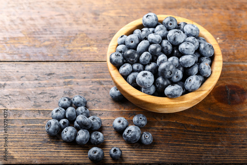 Fresh blueberries in a wooden bowl. Healthy and dietary food concept.