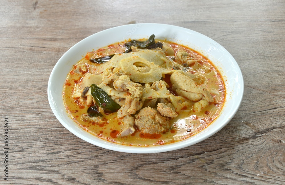 spicy boiled slice pickled bamboo shoot with chicken in coconut milk curry soup on plate spicy boiled slice pickled bamboo shoot with chicken in coconut milk curry soup on plate